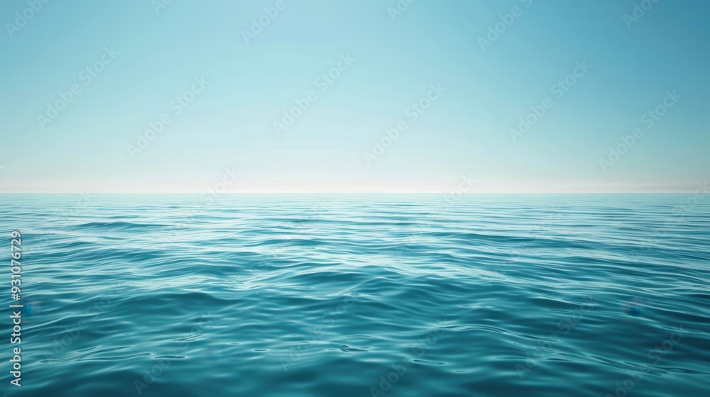 Fototapeta premium A calm ocean scene where the light blue water meets a pale horizon under a clear sky