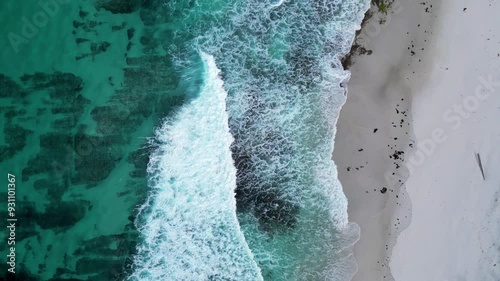 Aerial views over turquoise blue water and white sandy beach in Tasmania, Australia