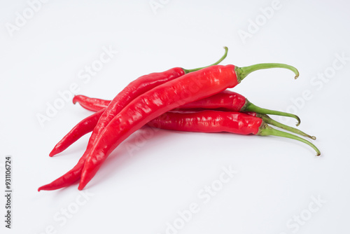 Fresh red chilli pepper on white background. File contains clipping paths. Closeup top view red chili pepper with sliced, raw food ingredient concept. Red hot chili peppers isolated, selective focus.