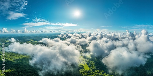 Beautiful aerial view of nature with white clouds and blue sky captured from a drone on a sunny day from high altitude in the front perspective