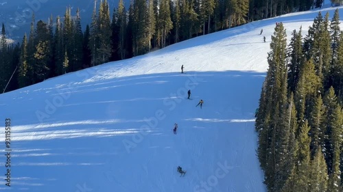 professional skiers slide on steep snowy alpine slope, winter vacation photo