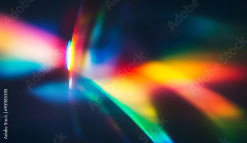 Abstract background with vibrant rainbow light streaks on dark background.
