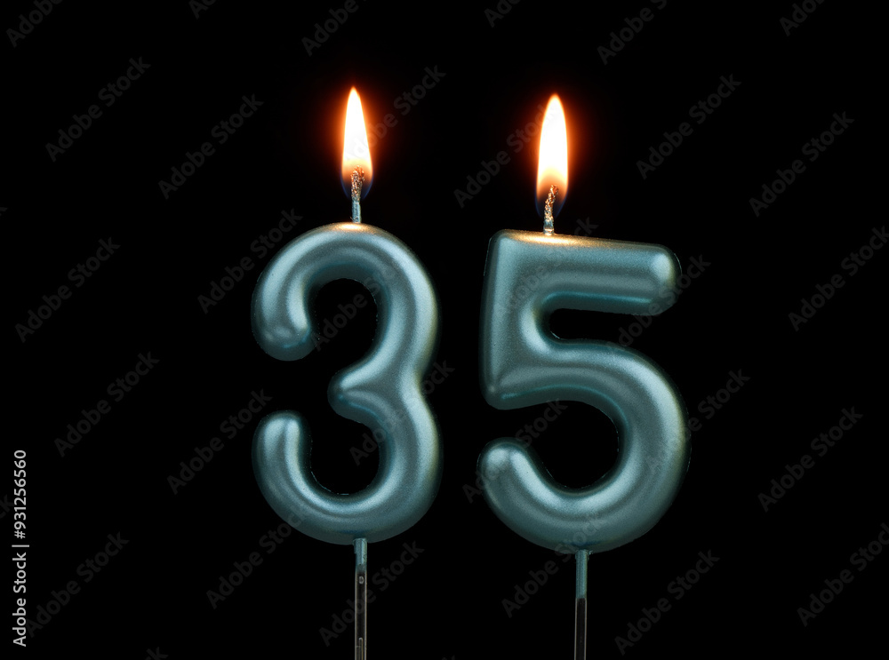 Burning blue birthday candles isolated on black background, number 35 Burning blue birthday candles isolated on black background, number 35