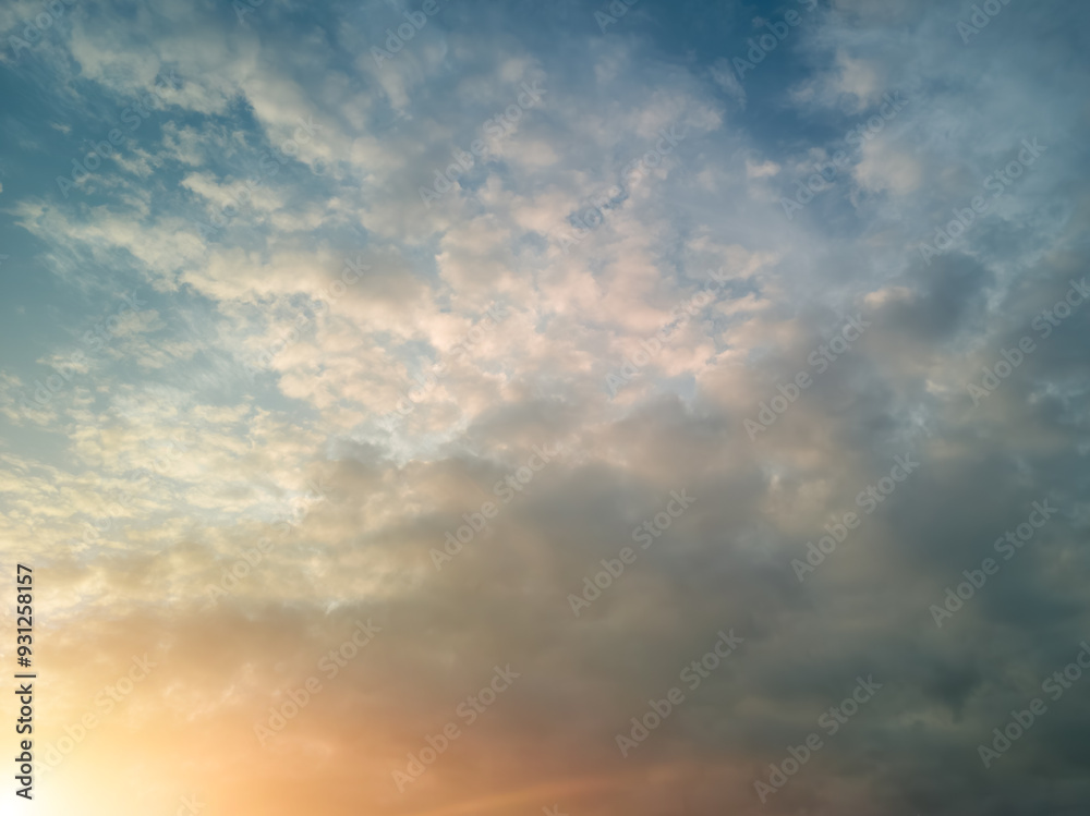 The rays of the sun breaking through the dramatic clouds in the evening or in the morning in the sunset or sunrise sky. The rays of the sun breaking through the dramatic clouds in the evening or in the morning in the sunset or sunrise sky.