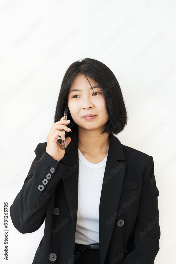Young asian woman talking on phone on white background. Young asian woman talking on phone on white background.