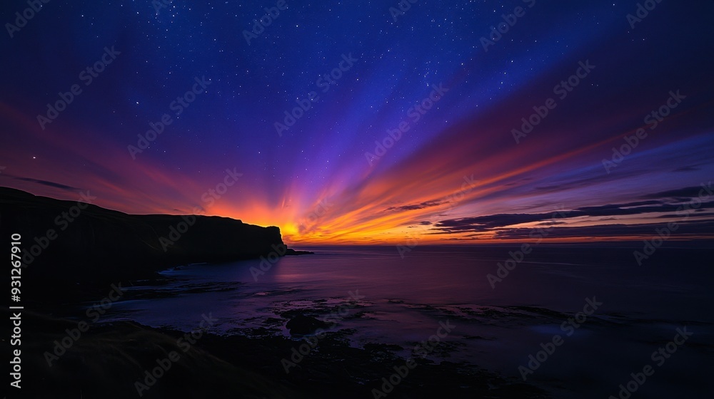 Fototapeta premium A stunning sunset over a coastal landscape, featuring vibrant colors and a starry sky.