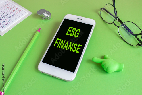 EGS FINANCE symbol. Concept words EGS FINANCE written on the mobile phone screen. Beautiful green background. Glasses, coins. Finance concept business succeed. photo