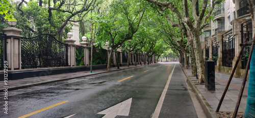 Photography A street in the French Concession in Shanghai with no one walking and trees on t