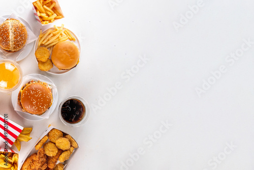 Fast food delivery menu background with various burgers, cheeseburger, nuggets, french fries, fizzy soda drinks. Junk unhealthy fast food, Ultra processed food with low nutrition, high calories value photo