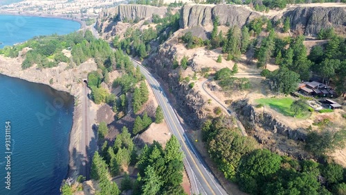 Drone aerial of cars transport driving along highway route road with mountain range hills valley Columbia river Lyle Washington Oregon USA America nature outdoors countryside land