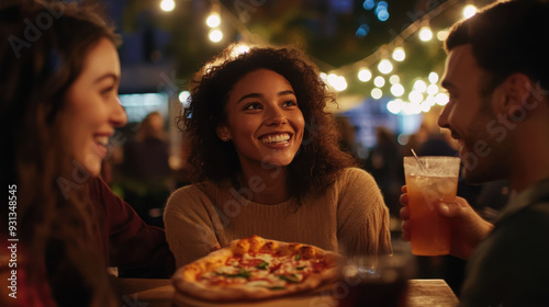 Young, diverse friends enjoying a relaxed night out, eating pizza and sipping drinks