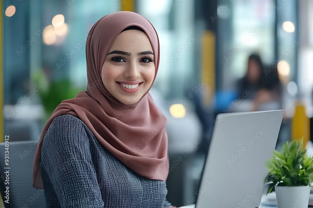 Smiling Arab Woman in Hijab Working at Office Desk Smiling Arab Woman in Hijab Working at Office Desk