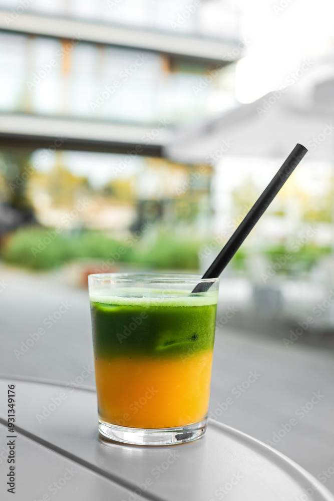Two layered matcha with orange juice in a glass Two layered matcha with orange juice in a glass