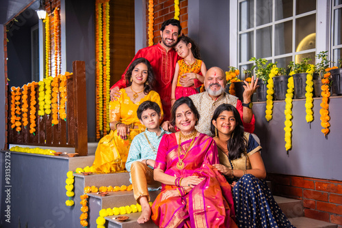 Photography Indian family in traditional attire taking a group selfie on steps in Diwali or