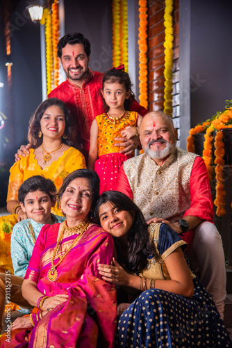Photography Indian family in traditional attire taking a group selfie on steps in Diwali or