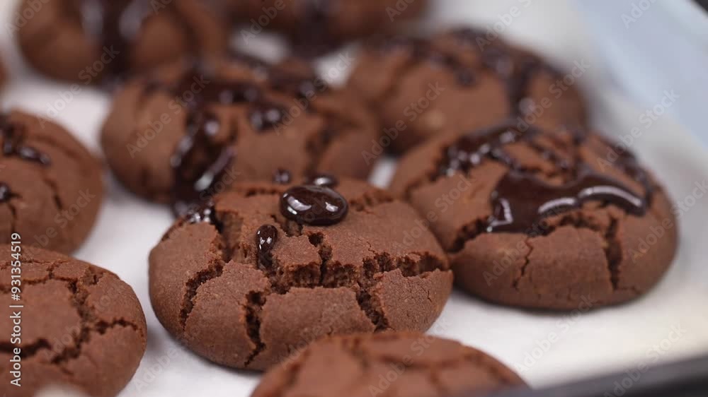 Pouring melted chocolate on the brown cookies. Pouring melted chocolate on the brown cookies.