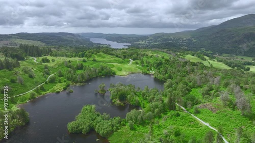 Flying over lake towards another distant lake. Tarn hows and Coniston Water, Lake District National Park, Cumbria, UK photo