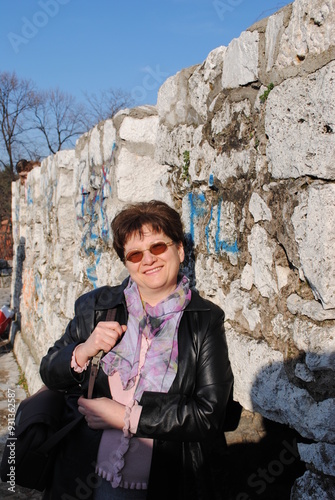 portrait of a woman by the old wall