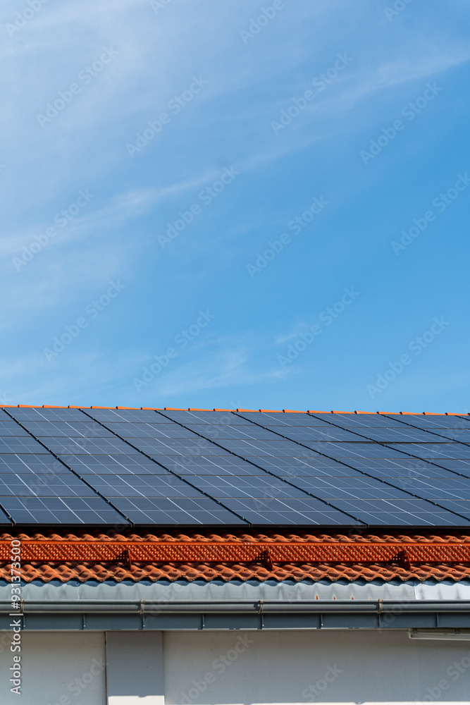 bunch of solar panels on roof during sunny day with blue sky bunch of solar panels on roof during sunny day with blue sky
