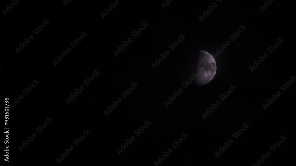 First quarter moon or waxing gibbous with amazing craters moving among mysterious clouds at night. Telephoto view, real midnight footage with black background. Creepy halloween sky, astrology concept. First quarter moon or waxing gibbous with amazing craters moving among mysterious clouds at night. Telephoto view, real midnight footage with black background. Creepy halloween sky, astrology concept.