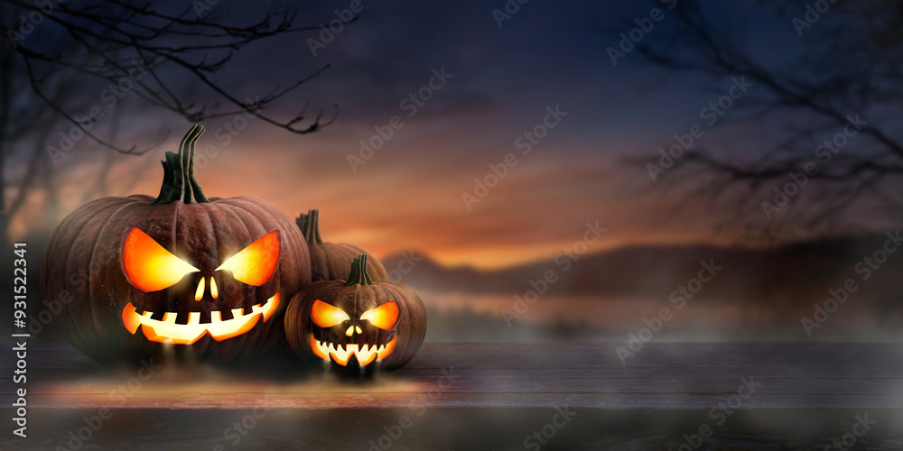 A scary spooky glowing carved halloween pumpkin lantern, Jack O' Lanterns, on the left of a wooden product display bench on a scary halloween night.