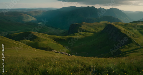 Sunlight illuminating winding road through lush green mountain valley