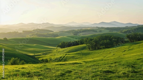 A vibrant green landscape with rolling hills and distant mountains under a clear sky