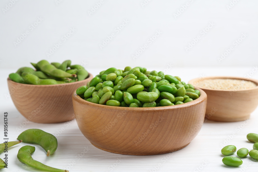 Fresh edamame soybeans, pods and seeds on white wooden table, closeup Fresh edamame soybeans, pods and seeds on white wooden table, closeup