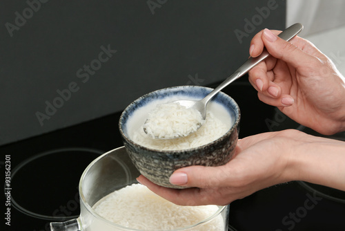 Wallpaper Mural Woman taking boiled rice from pot into bowl, closeup Torontodigital.ca