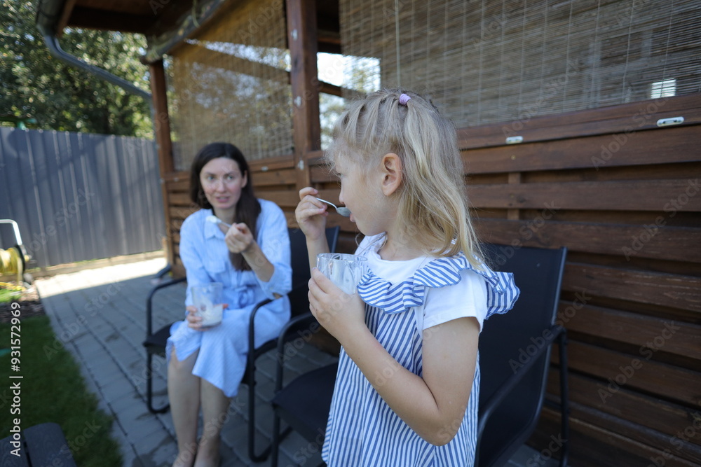 Fototapeta premium Mother and a child eating ice cream at home