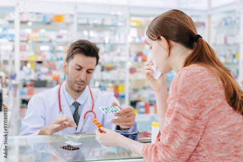 Woman is sick with a cold and has a runny nose. Buying medicine from the pharmacist at the drug store. Choose the type of medicine according to the instructions. photo