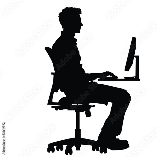 Silhouette of a man at a desk working on a computer in a side profile view.