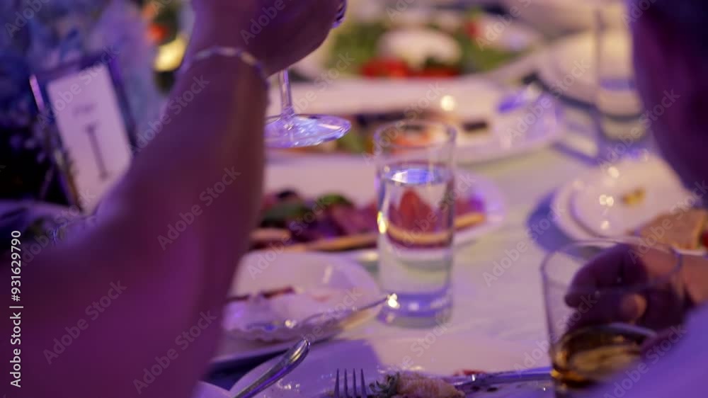 Festive table in a restaurant, people have dinner, celebration background
