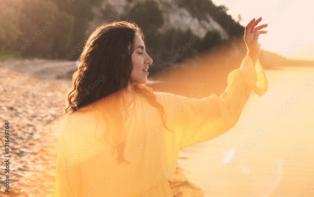 Fototapeta premium Beautiful young woman in the sun rays