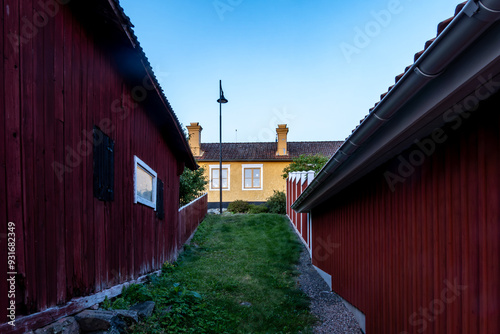 Osthammar, Sweden Cute and small wooden houses in a downtown alley. photo