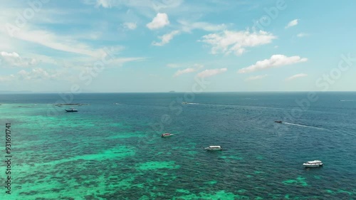 Boats on turquoise water, seascape, speed, tour, aerial shot, Phi Phi, sky. Beautiful nature, sea air, speed boat tour around the islands of Thailand, snorkeling, coral reef. High quality 4k footage
