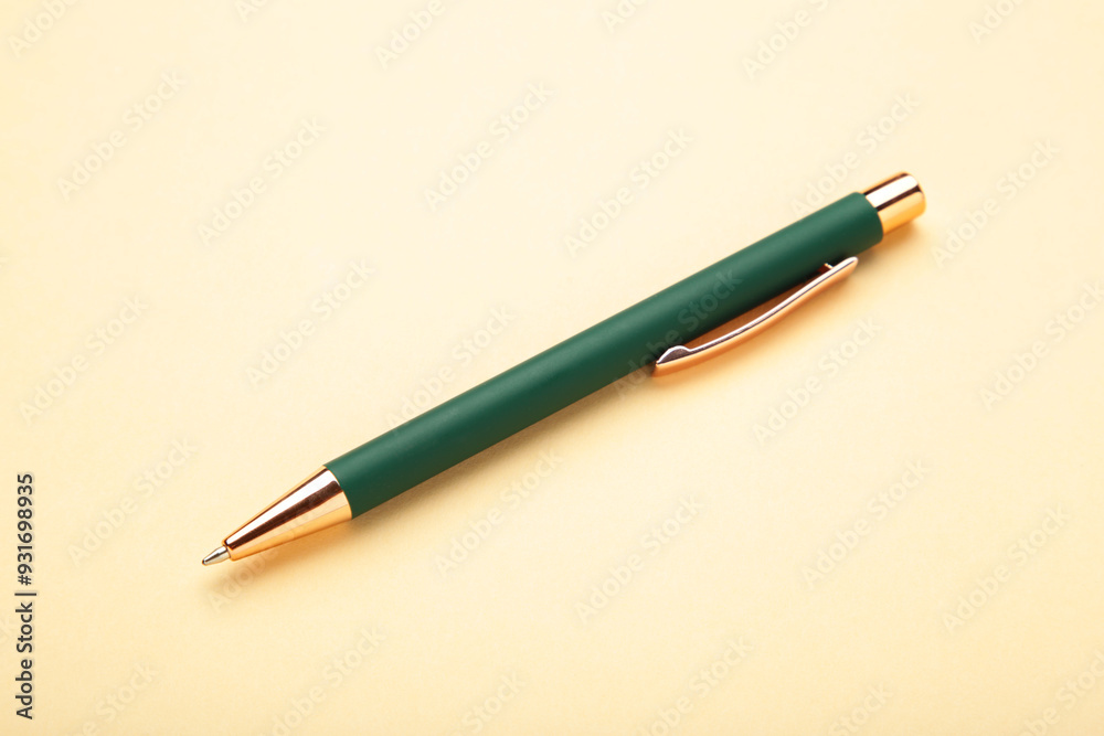 New stylish green pen on beige background. Top view New stylish green pen on beige background. Top view