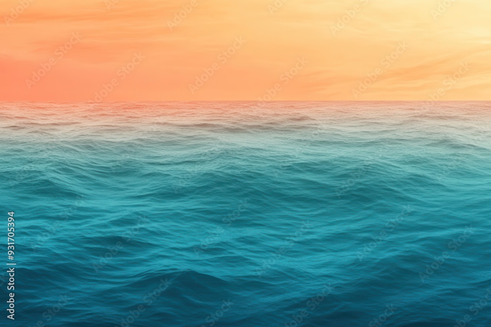 Fototapeta premium A gradient moving from a warm orange to a cool teal with a subtle grain effect, resembling a sunset over the ocean.