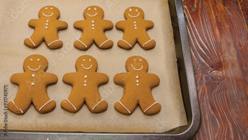 Gingerbread Men Cookies on a Baking Sheet on a Wooden Table