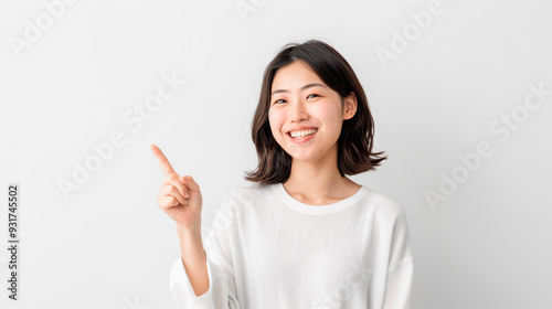 Asian girl pointing finger to the side 