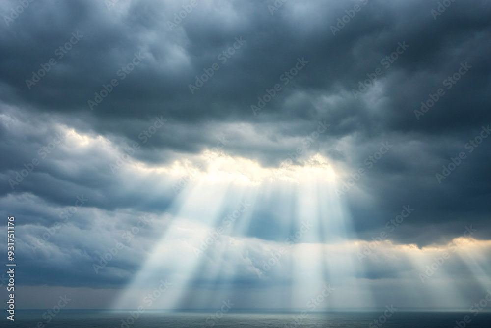 Dramatic Sunbeams Through Dark Clouds Above the Ocean Dramatic Sunbeams Through Dark Clouds Above the Ocean