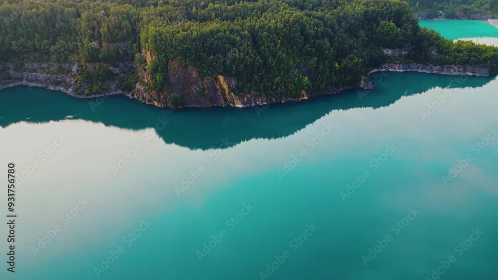 Aerial drone top down view of lake among forest with beautiful turquoise water in summer day, mountains and tree tops. Aerial drone top down view of lake among forest with beautiful turquoise water in summer day, mountains and tree tops.