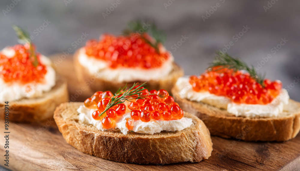 Bruschetta with cream cheese and red caviar on wooden board. Delicious snack. Tasty delicacy.