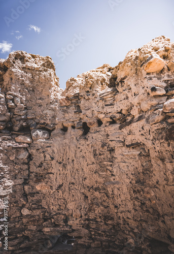 Remains of the ancient fortress of Yamchun in the Tien Shan mountains in Tajikistan in the Pamirs, ruins of a fortress fort made of stone on the background of mountains photo