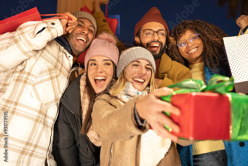 Cheerful group of friends with Christmas presents having fun in winter. High quality photo