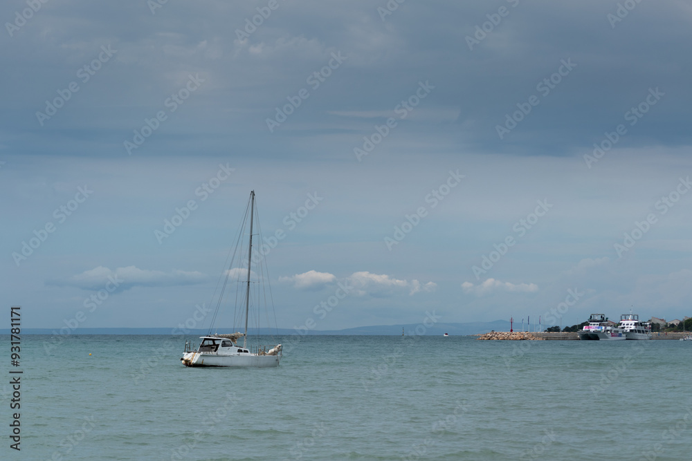 Moored yacht in Adriatic sea during overcast day Moored yacht in Adriatic sea during overcast day