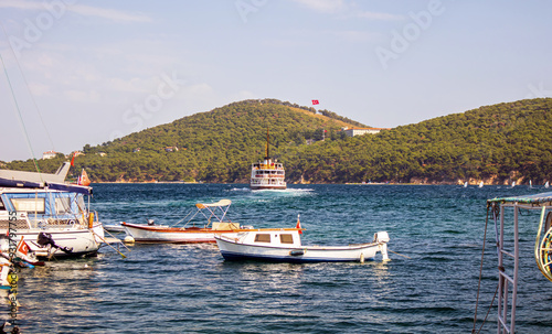 view of forested island and boats in the bay of burgazada island, prince islands, adalar, istanbul photo