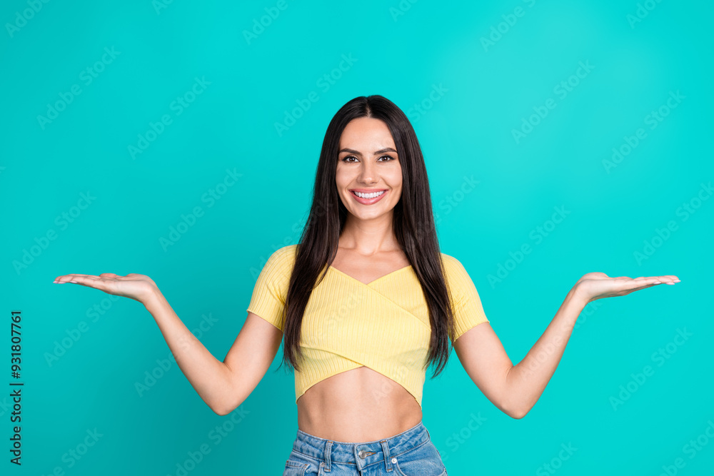 Portrait of pretty young woman hold empty space wear top isolated on turquoise color background Portrait of pretty young woman hold empty space wear top isolated on turquoise color background
