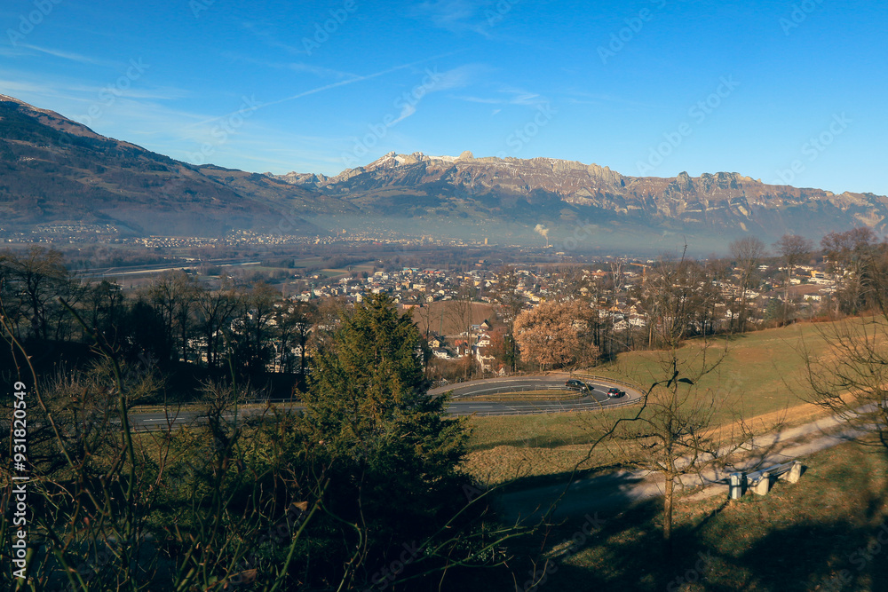 Fototapeta premium Panoramic view of Vaduz with mountains and valley under clear blue sky