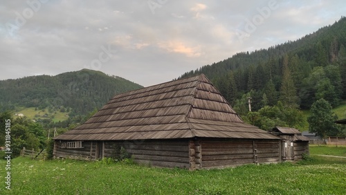 old wooden house against the backdrop of mountains